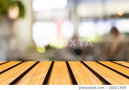 Selected focus empty brown wooden table and Coffee shop blur bac 18821369