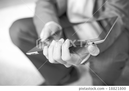 Businessman using electronic tablet pc. He is sitting on a stair Businessman using electronic tablet pc. He is sitting on a stair 18821800