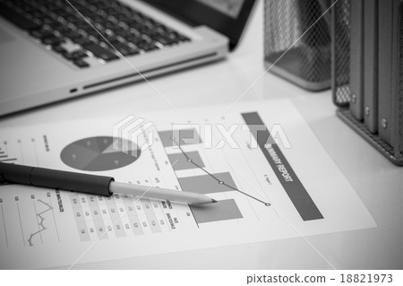 Analyzing investment charts with laptop. Accounting Analyzing investment charts with laptop. Accounting 18821973