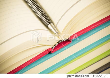 Close-up of open book and pen Close-up of open book and pen 18822129