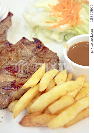 Pork steak with French Fries. 18823606