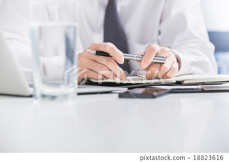 Businessman analyzing data in office 18823616