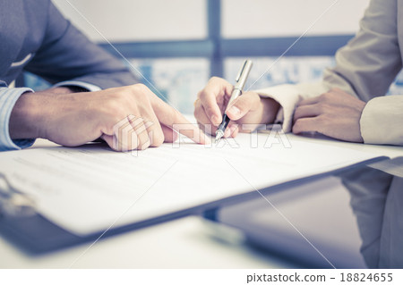 Stock Photo: Female hand signing contract.