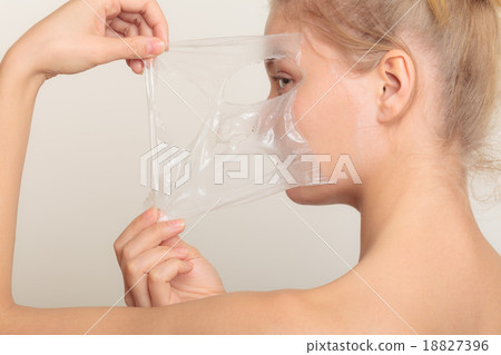 girl removing facial peel off mask 18827396