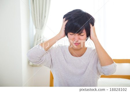 Headache hangover fatigue fatigue tired of sickness poor physical condition of young men in their teens or 20s portrayed Headache hangover fatigue fatigue tired of sickness poor physical condition of young men in their teens or 20s portrayed 18828102