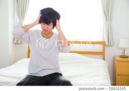 Headache hangover fatigue fatigue tired of sickness poor physical condition of young men in their teens or 20s portrayed Headache hangover fatigue fatigue tired of sickness poor physical condition of young men in their teens or 20s portrayed 18828105