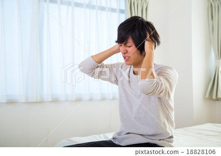 Headache hangover fatigue fatigue tired of sickness poor physical condition of young men in their teens or 20s portrayed Headache hangover fatigue fatigue tired of sickness poor physical condition of young men in their teens or 20s portrayed 18828106