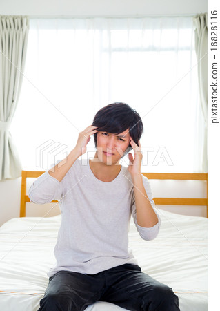 Headache hangover fatigue fatigue tired of sickness poor physical condition of young men in their teens or 20s portrayed Headache hangover fatigue fatigue tired of sickness poor physical condition of young men in their teens or 20s portrayed 18828116