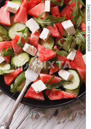 圖庫照片: salad of watermelon, cheese, arugula and cucumbers