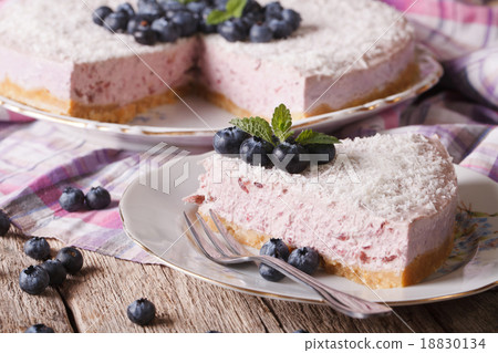 Cutting slice of delicious blueberry cheesecake Cutting slice of delicious blueberry cheesecake 18830134