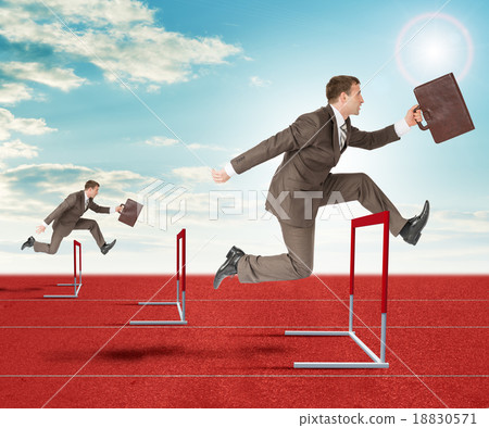 Businessmen hopping over treadmill barrier Businessmen hopping over treadmill barrier 18830571
