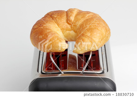 one croissant on red hot toaster 18830710