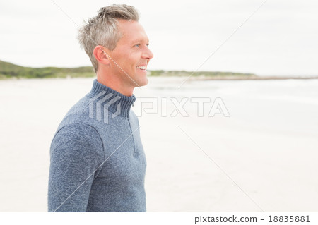 Smiling man standing by the sea 18835881