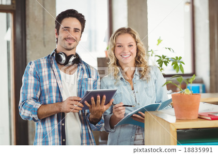 Portrait of happy business people holding digital tablet in crea Portrait of happy business people holding digital tablet in crea 18835991
