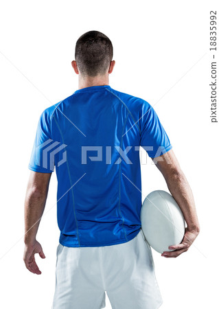 Rear view of rugby player holding ball aside 18835992