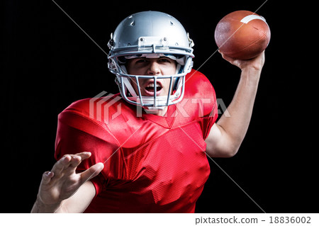 Portrait of American football player throwing ball Portrait of American football player throwing ball 18836002