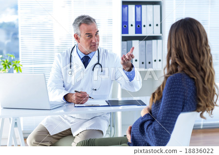 Male doctor advising pregenat woman in clinic Male doctor advising pregenat woman in clinic 18836022