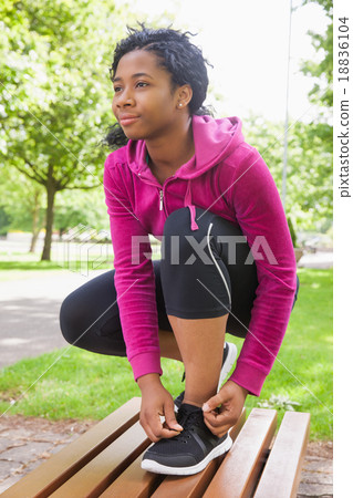 Hipster tying her shoelace Hipster tying her shoelace 18836104
