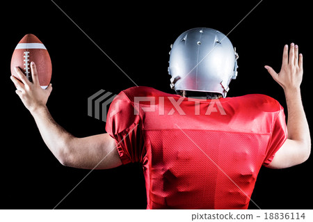 Rear view of American football player gesturing while holding ba Rear view of American football player gesturing while holding ba 18836114