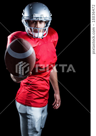 Confident American football player showing ball Confident American football player showing ball 18836472