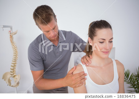 Doctor examining his patient arm 18836475