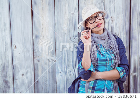 Happy hipster holding a paintbrush Happy hipster holding a paintbrush 18836671