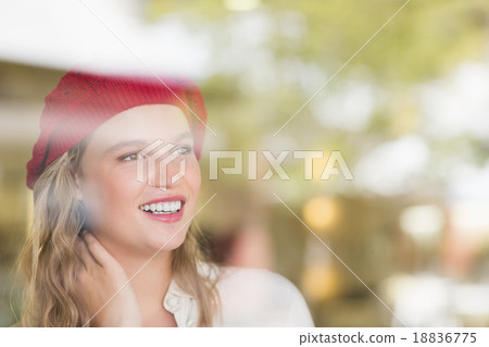 A blonde woman looking through the windows 18836775