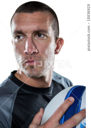 Close-up of confident rugby player holding ball Close-up of confident rugby player holding ball 18836929
