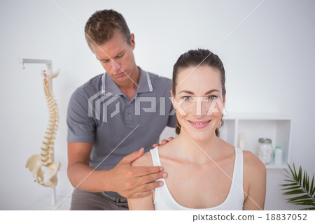 Doctor examining his patient arm 18837052