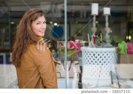 Portrait of smiling woman in front of window looking at camera Portrait of smiling woman in front of window looking at camera 18837133