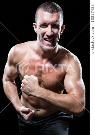 Excited shirtless man flexing muscles 18837488
