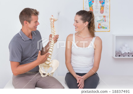 Doctor showing anatomical spine to his patient Doctor showing anatomical spine to his patient 18837491