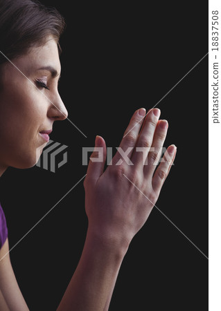 Woman praying with hands together 18837508