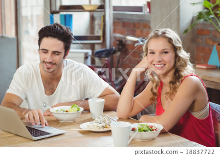 Portrait of smiling business sitting by colleague Portrait of smiling business sitting by colleague 18837722