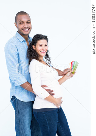Portrait of smiling husband with wife holding colour samples 18837747
