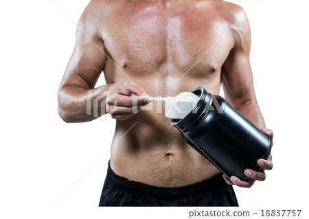 Midsection of shirtless man scooping up protein powder 18837757