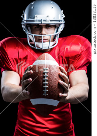 Portrait of American football player holding ball Portrait of American football player holding ball 18838119