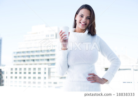 Beautiful brunette drinking a coffee 18838333