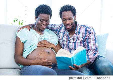 Pregnant woman smiling with partner Pregnant woman smiling with partner 18838367