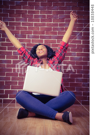Hipster cheering and using laptop 18838448