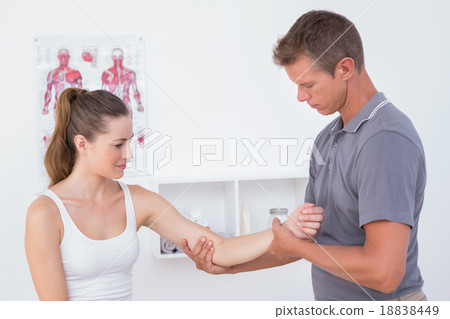 Doctor examining his patient arm 18838449