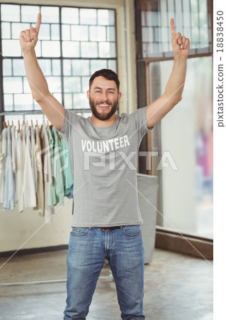 Man with arms raised standing in office 18838450