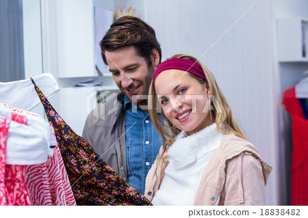 Smiling couple browsing clothes Smiling couple browsing clothes 18838482