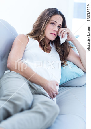 Sad pregnant woman relaxing on sofa 18838529