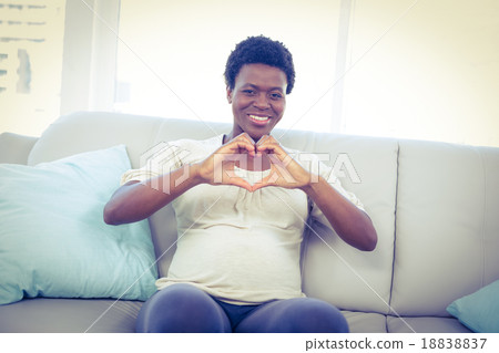 Portrait of pregnant woman making heart shape with hands 18838837