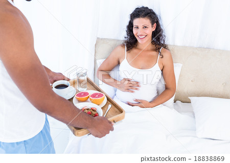Husband with breakfast tray for pregnant wife 18838869