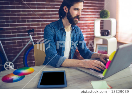 Creative businessman using using laptop by graphic tablet on des Creative businessman using using laptop by graphic tablet on des 18839089