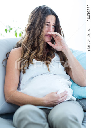 Pregnant woman crying at home Pregnant woman crying at home 18839285