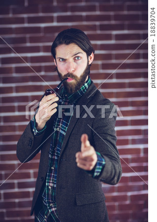 Portrait of confident man with smoking pipe pointing finger 18839704