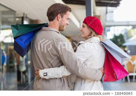 A happy couple with shopping bags 18840065